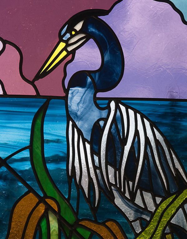 a blue heron on purple background